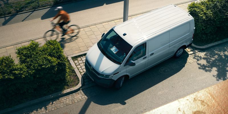The Transporter 6.1 Delivery Van turns right onto a street.