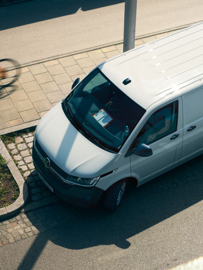 The Transporter 6.1 Delivery Van turns right onto a street.