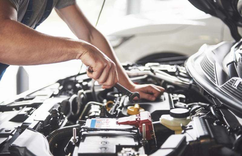 Mecánico de taller oficial Volkswagen reparando motor