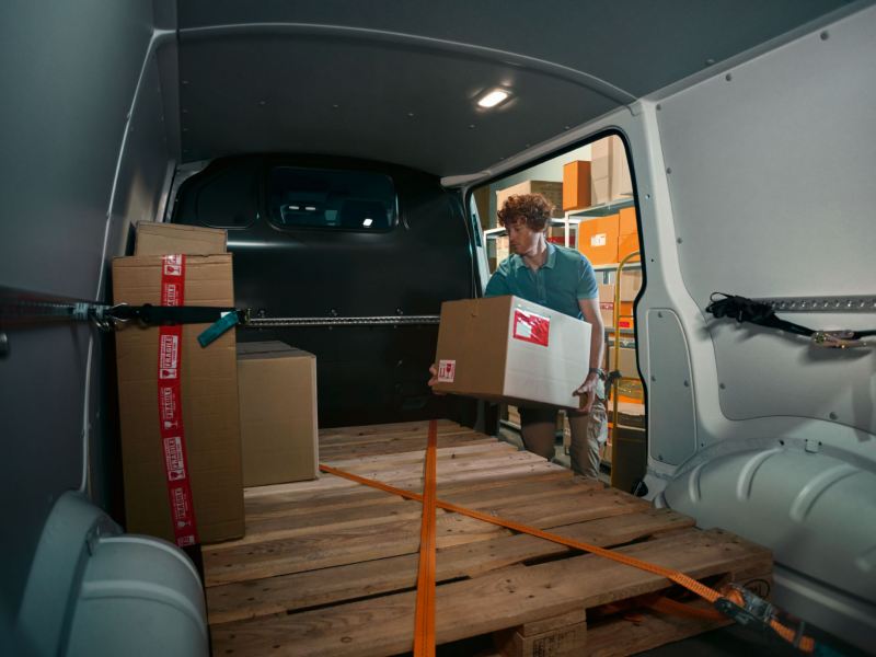 man loading cardo into transporter panel van 6.1