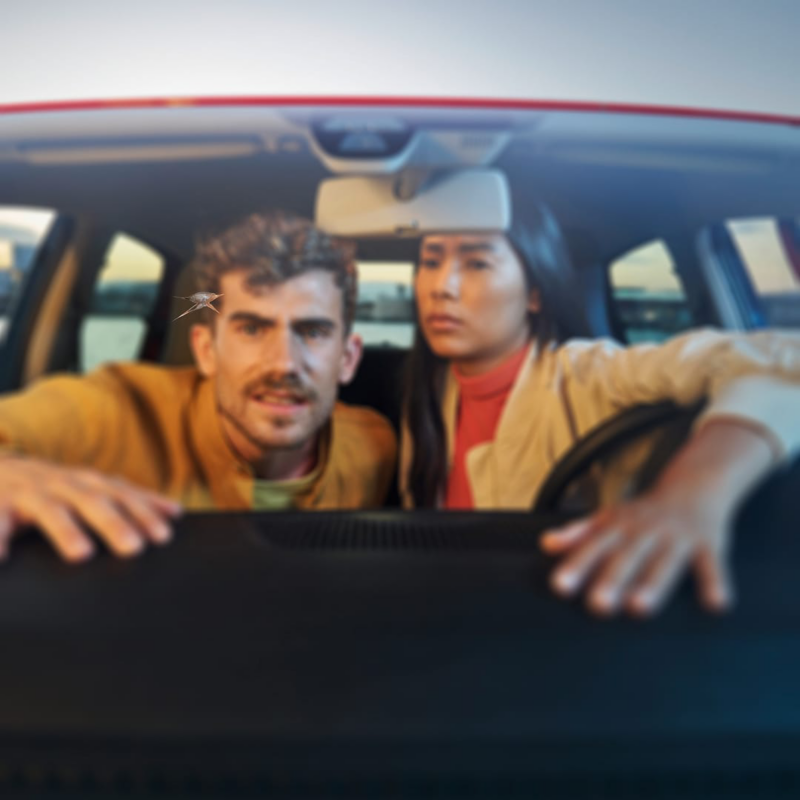 Un hombre y una mujer mirando desde el interior de un Volkswagen