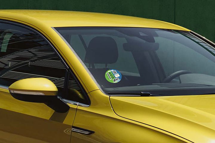 Un Volkswagen Golf 8 amarillo con el sello ECO de la DGT en el parabrisas