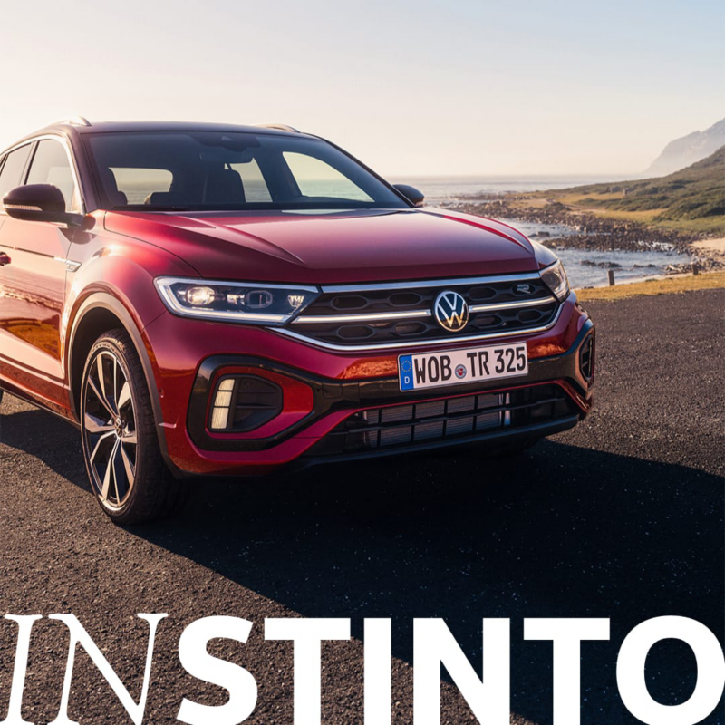 Detalle frontal Volkswagen T-Roc rojo con una playa detrás