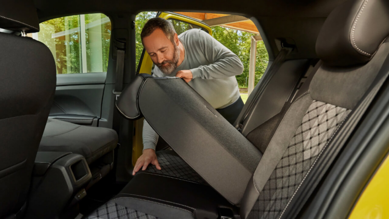 Un hombre manipulando un asiento de un Volkswagen T-Cross