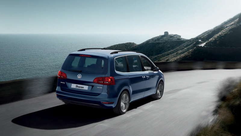 A Blue Sharan car driving on the road 