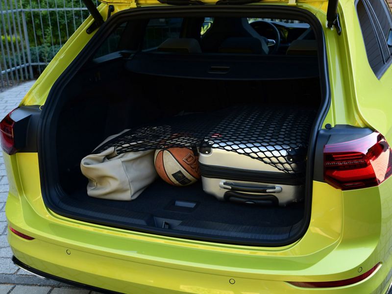 A opened booth of a VW Golf Estate with 3 items inside