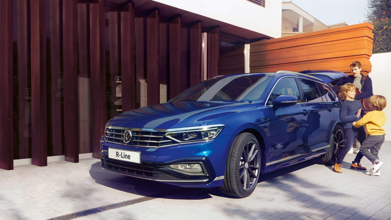 A family loading a Blue Passat estate car