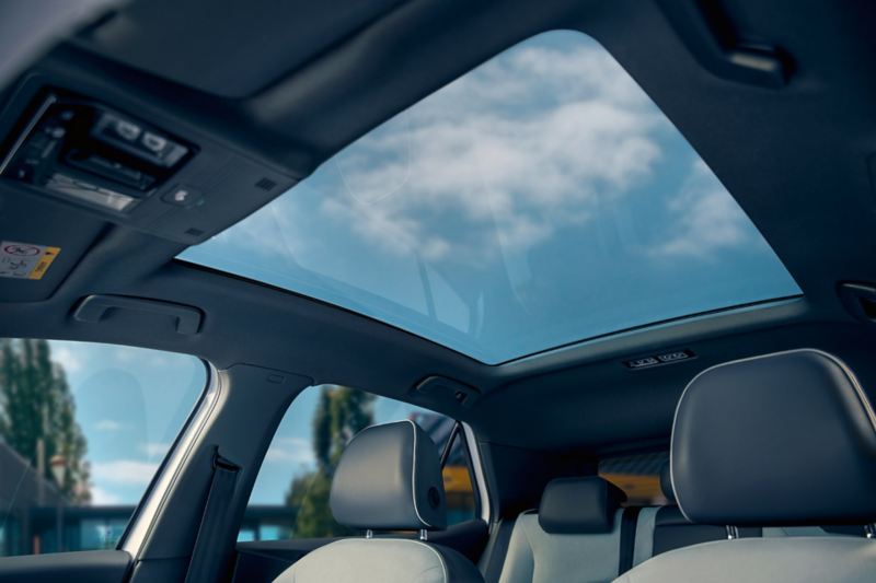 A view of a cloudy blue sky through the ID.3 panoramic sunroof.