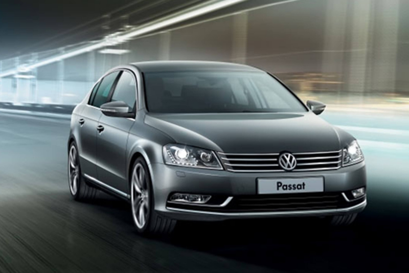 A grey Volkswagen Passat, driving through a tunnel.