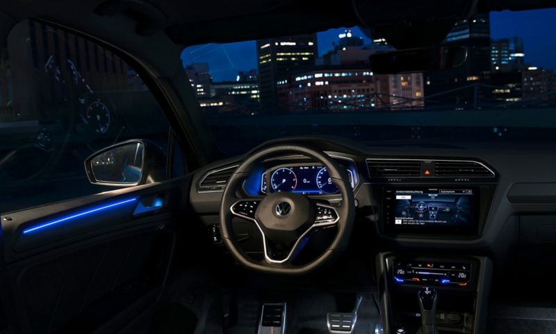 A view of the New Tiguan cockpit from the drivers seat, hilighting it's ambient lighting.