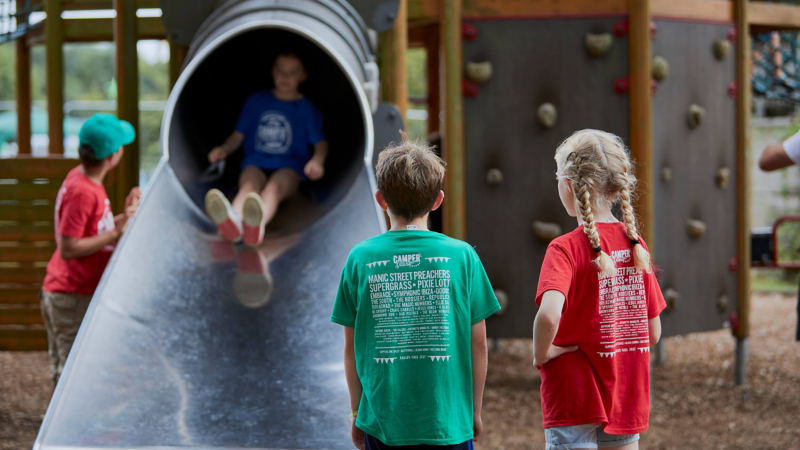 Children playing on a slide at the van festival. 