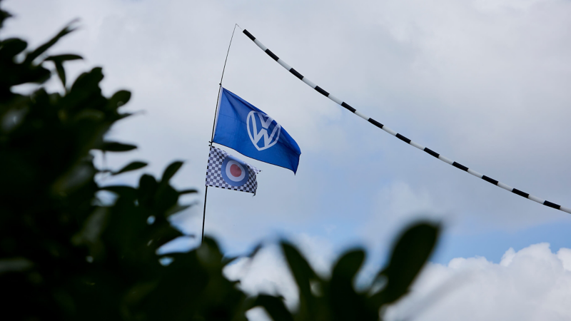 Two flags flying in the breeze at the van festival. 