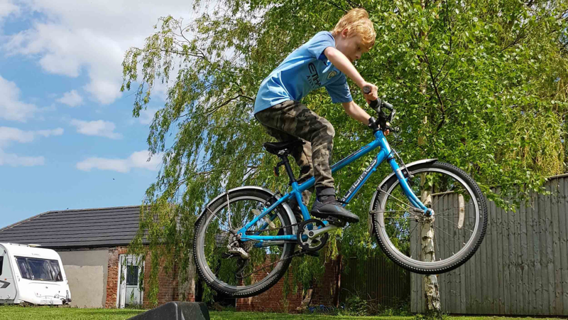 Photo showing a boy riding a bicycle. 