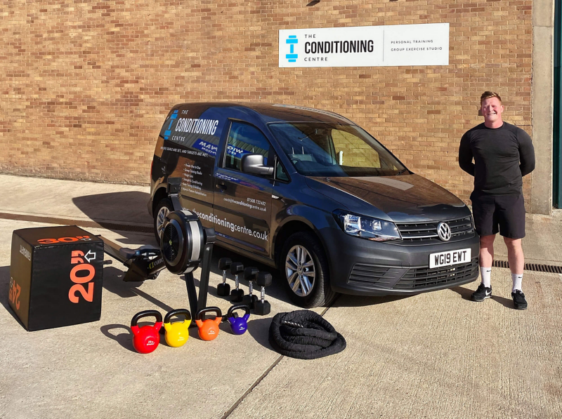 Joel Thomas of Conditioning Centre standing next to a Volkswagen Caddy