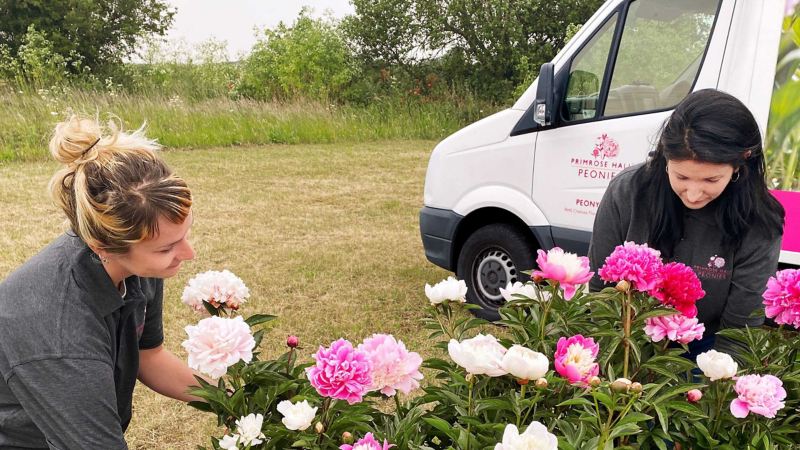 Primrose Hall with peonies next to their converted Volkswagen Crafter