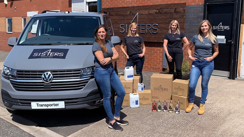 SIS4ERS DISTILLERY team standing next to their Volkswagen Transporter van