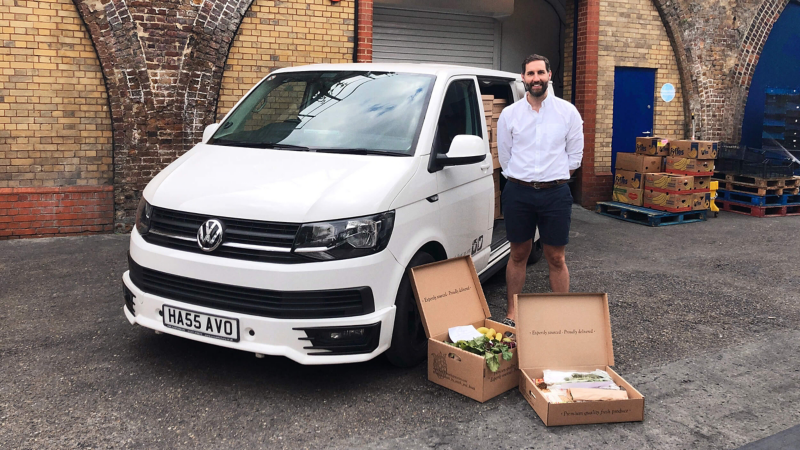 Nick, director of Smith & Brock standing next to a Volkswagen Transporter panel van