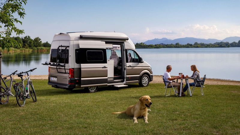 A couple sat at a table next to a park Grand California against a lake background. 