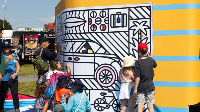 Photo showing attendees looking at a display at CarFest 2024.