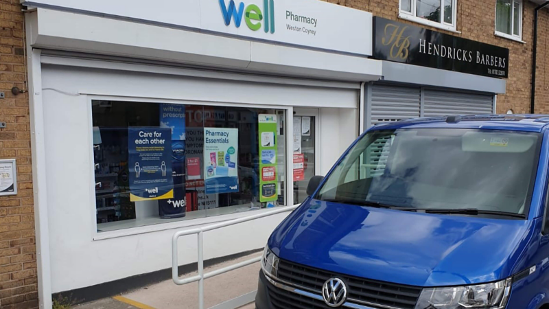 Transporter T6.1 in front of a Wells pharmacy