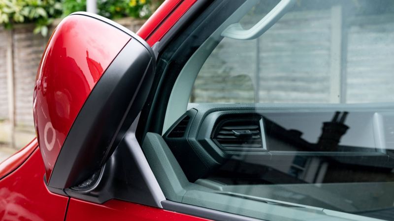 A closeup of a VW vans folded wing mirror.