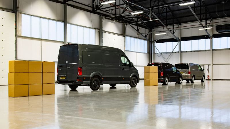 panel van parked between cardboard boxes