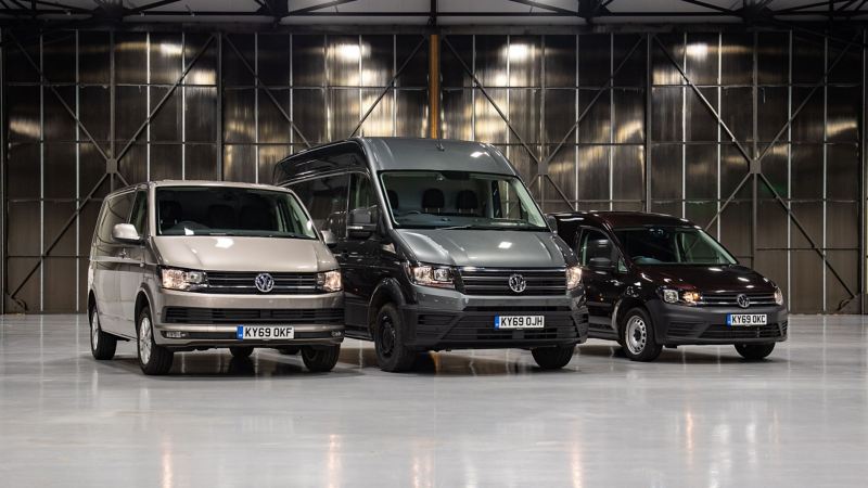 three panel vans in warehouse side by side 