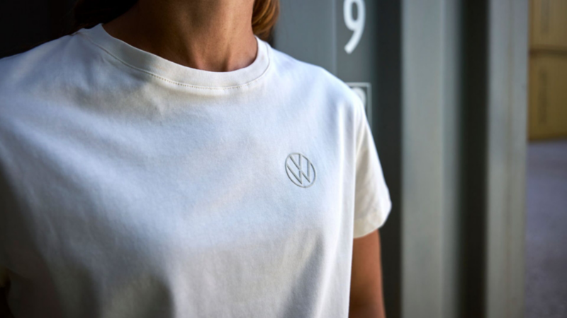 Persona con playera blanca Volkswagen Essentials y logo Volkswagen.