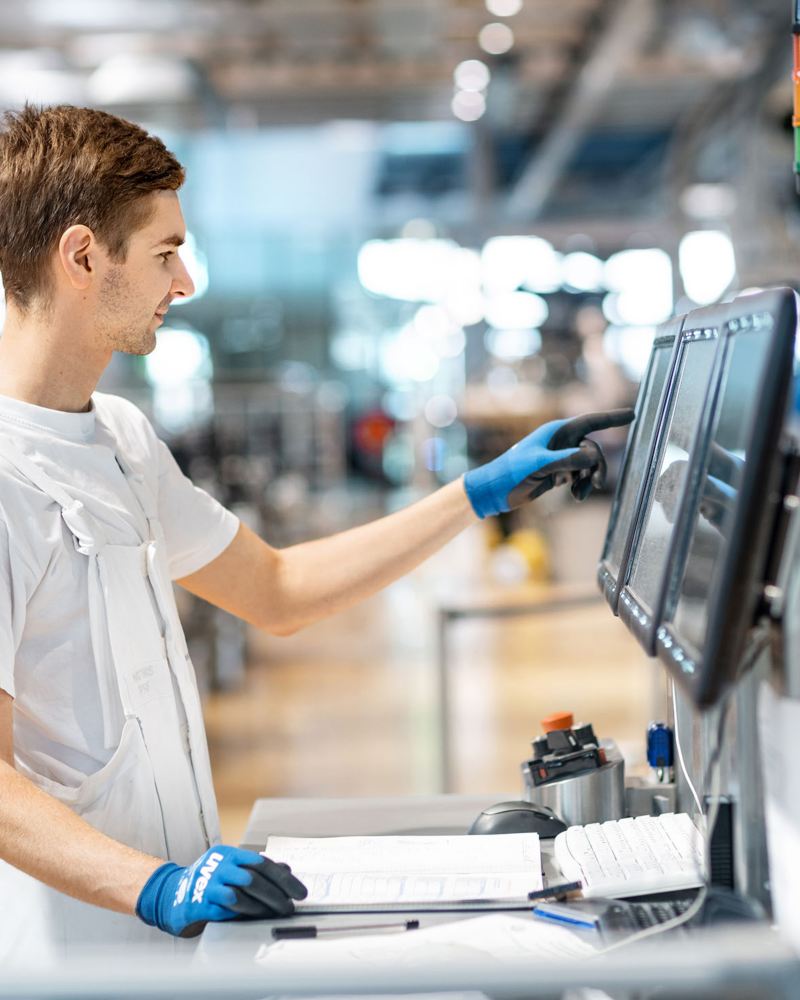 A man checking a computer screen on the production line