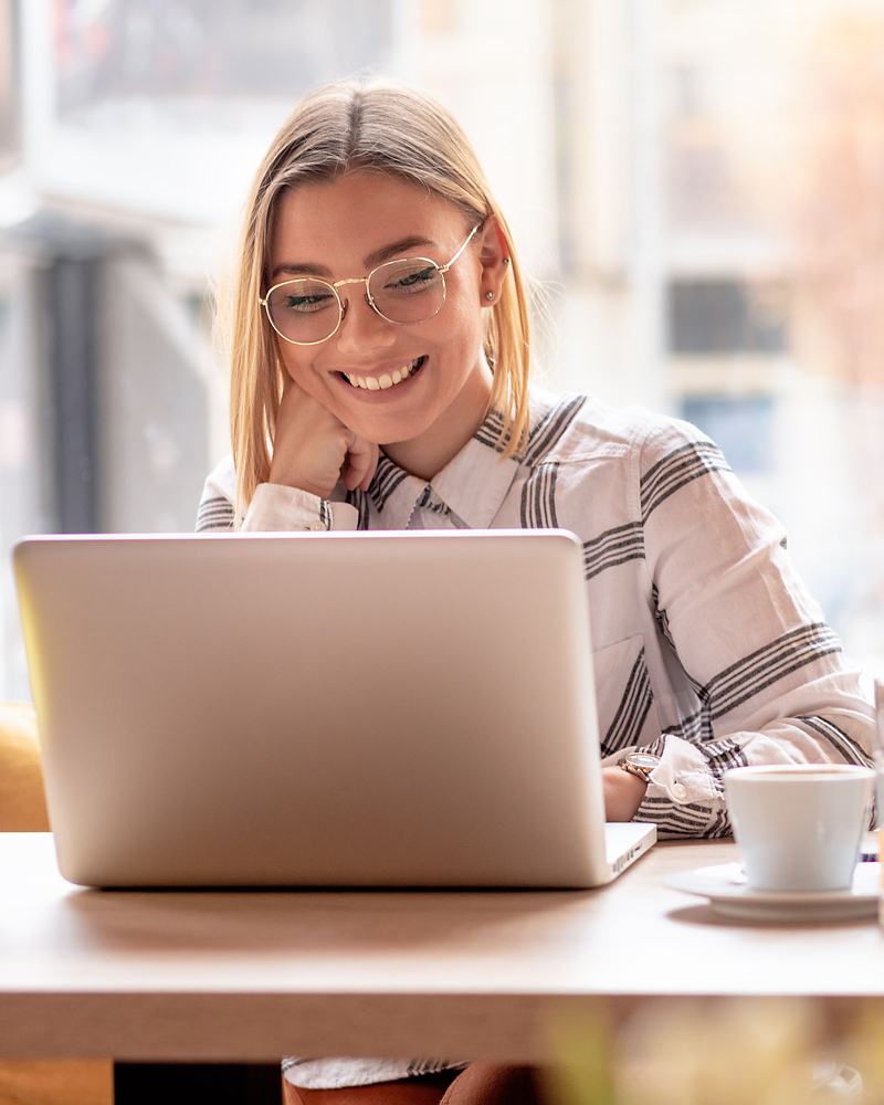 A young Volkswagen professional sitting at a desk in front of her laptop