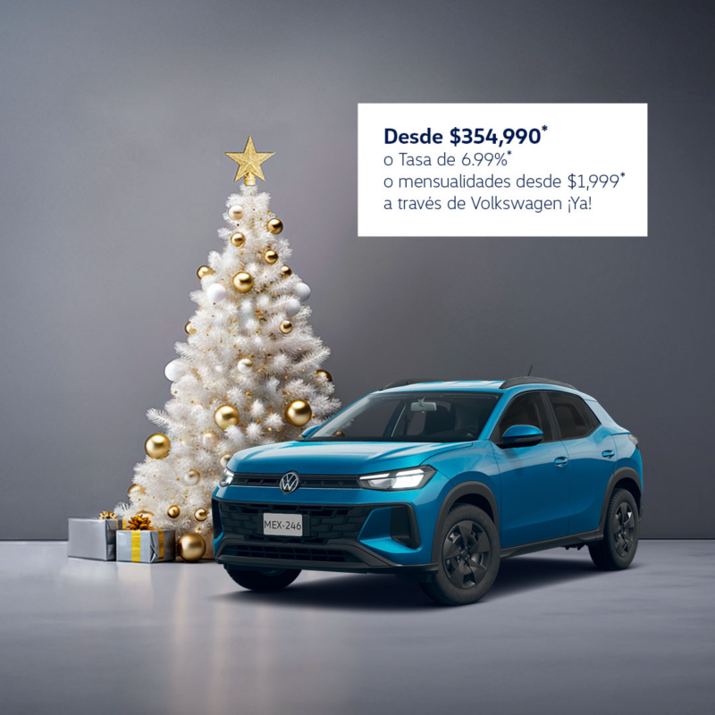 Volkswagen Tera azul junto a árbol de navidad blanco y regalos.