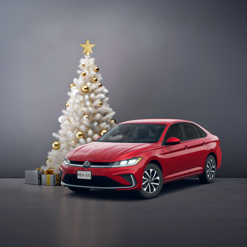 Volkswagen Jetta rojo junto a árbol de navidad blanco y regalos.
