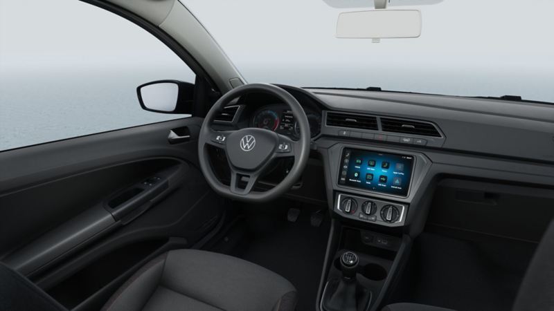 Interior de Saveiro 2025 con volante, pantalla touch y panel de control de aire acondicionado. 