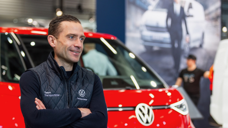 Markus Ostermeir, märkeschef för VW Transportbilar, står framför en röd VW ID. Buzz