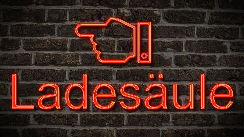 Rotes Neon mit roter Hand, Schrift „Ladesäule“