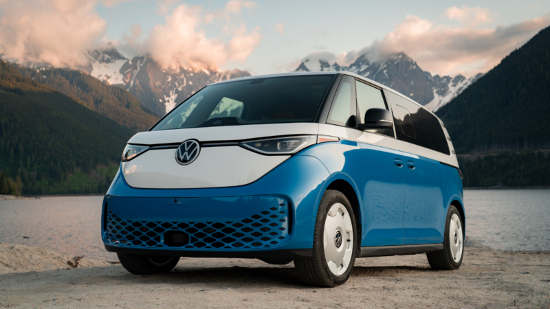 A blue and white ID. Buzz with a mountain range in background 
