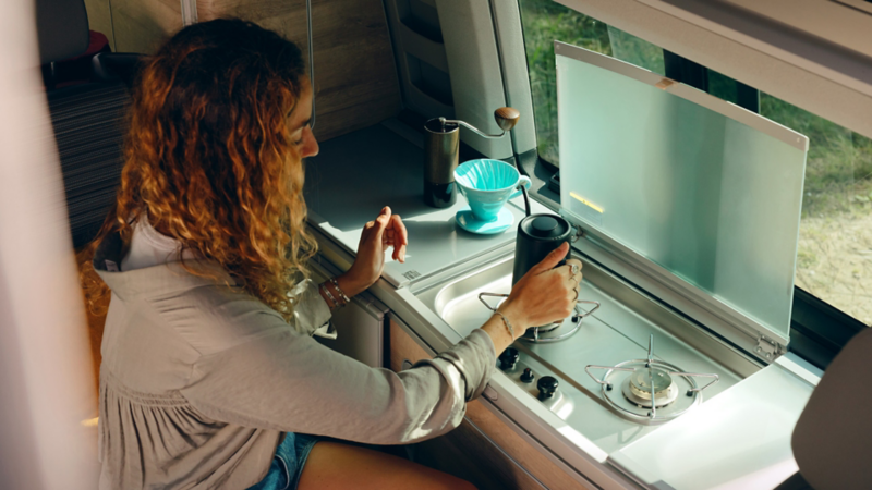 Woman making tea on the California stove