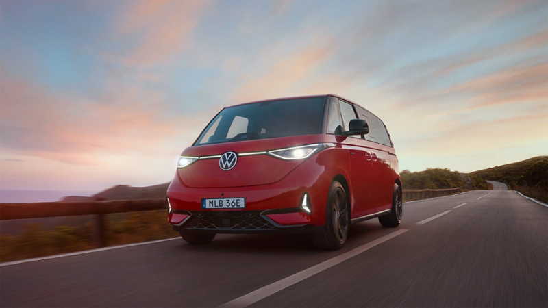 En röd VW ID Buzz GTX fyrhjulsdriven elbil kör på landsväg