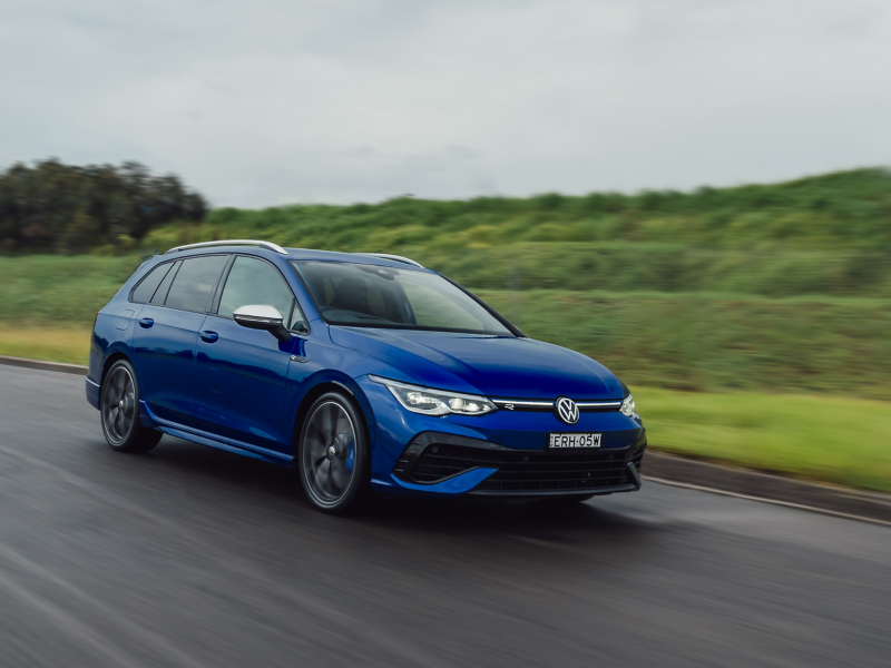 Blue VW driving on the road 