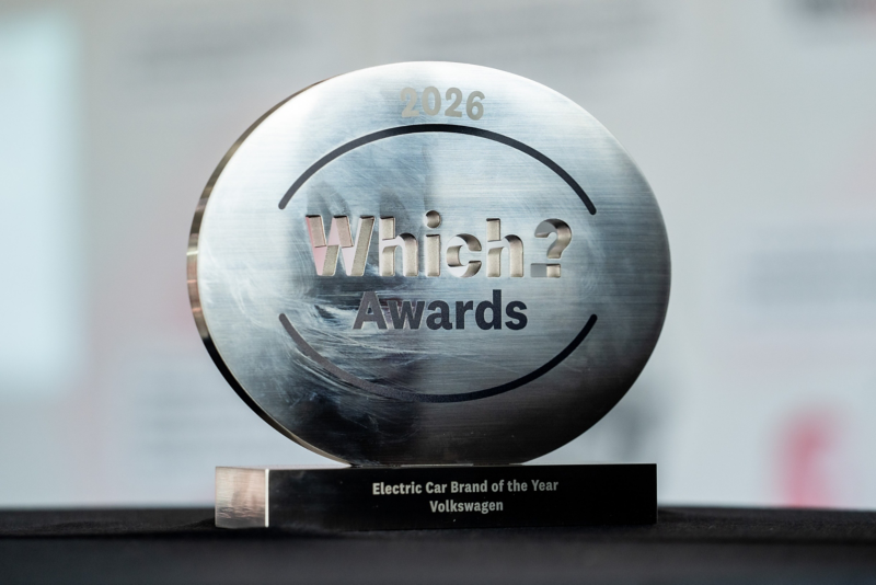 Close-up of a circular metallic "Which? Awards 2026" trophy on a black base that reads "Electric Car Brand of the Year Volkswagen".
