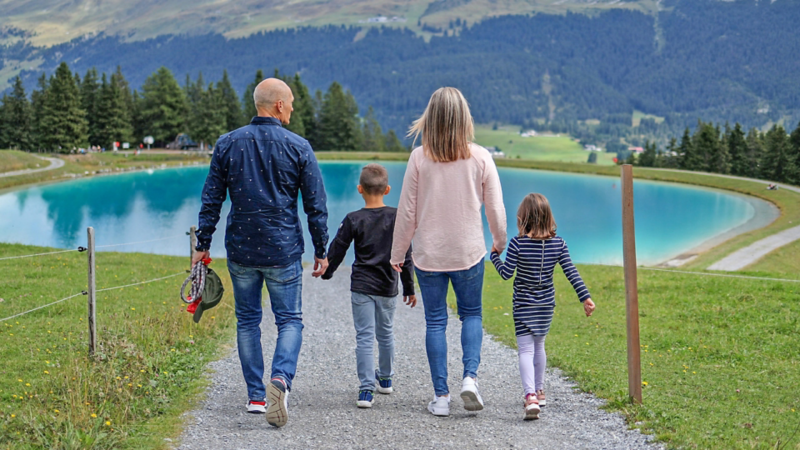 Eine Familie mit Hund auf dem Weg zum See