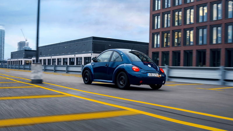 Blue Beetle driving in car park