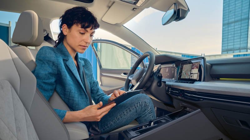 A man and a woman are both looking at a phone screen