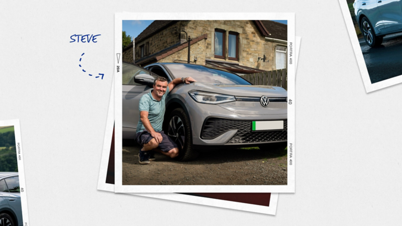 A man crouching down besides his VW ID with the drivers door open and a house in the background