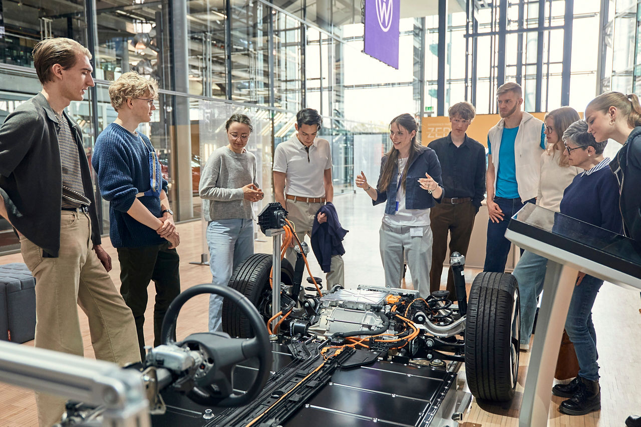 Besuchergruppe mit Guide vor dem MEB Modell in der Gläsernen Manufaktur