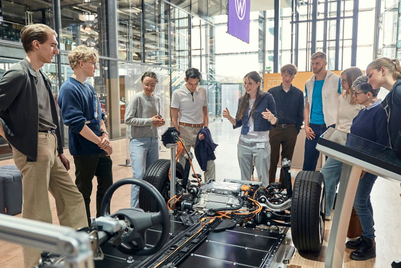 Group of visitors with guide in front of the MEB model in the Gläserne Manufaktur