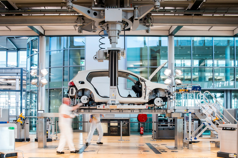 A white e-Golf in the joining device (so-called wedding station) in the Transparent Factory