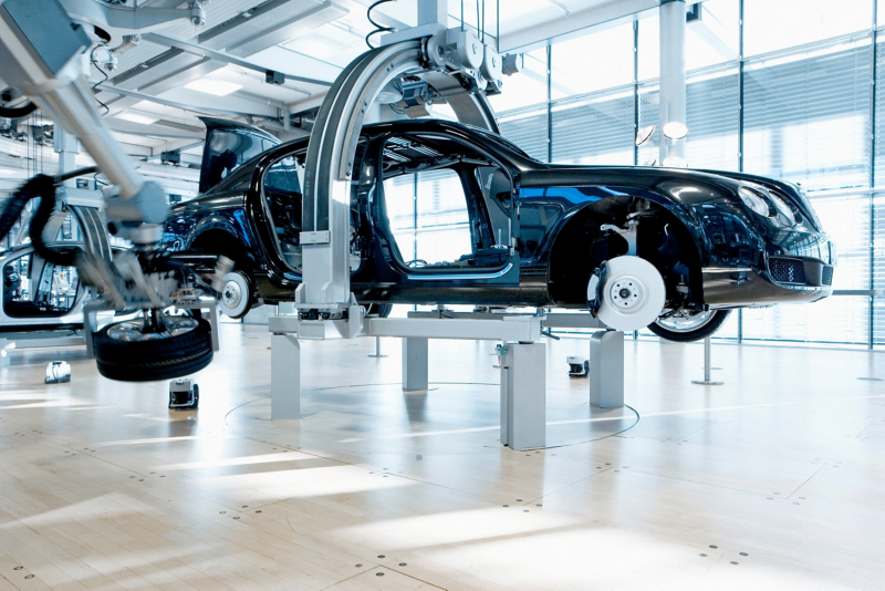 Bentley Flying Spur body shell with mounted components on the suspension system inside the Transparent Factory.