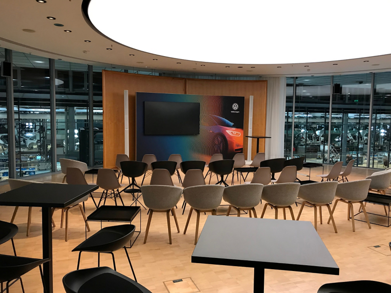 ID Circle with chairs, tables and video wall for an event in VW's Transparent Factory