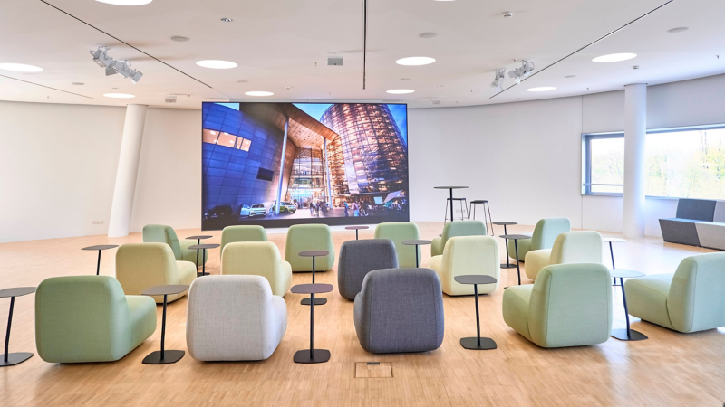 Innenansicht des ID Studio mit Sitzmöbeln und Medienwand